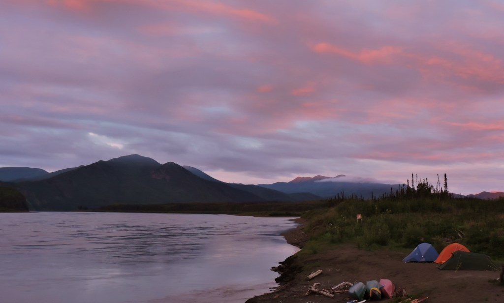 Yukon River with tents and canoes on bank